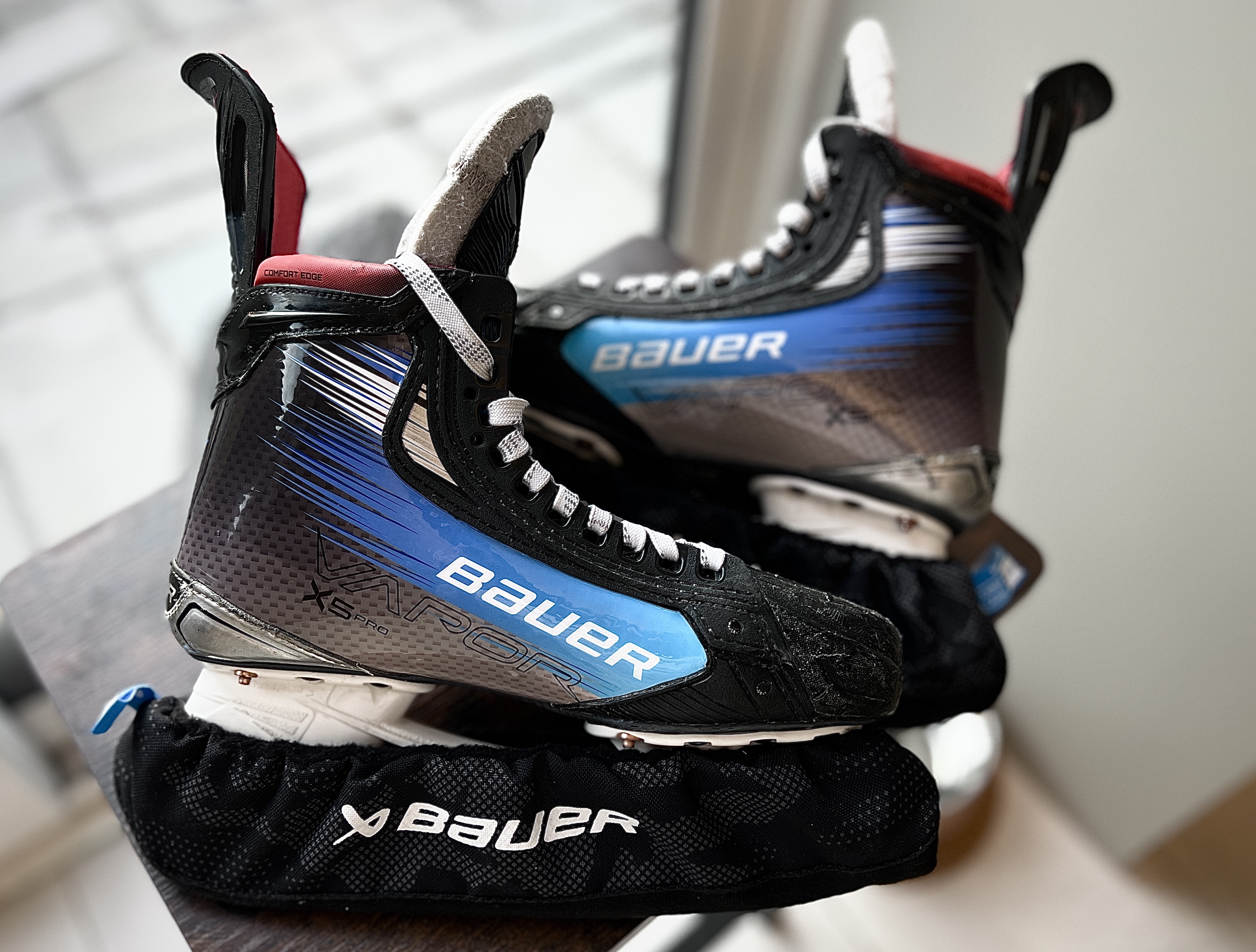 Pair of blue custom wrapped Bauer Vapor hockey skates